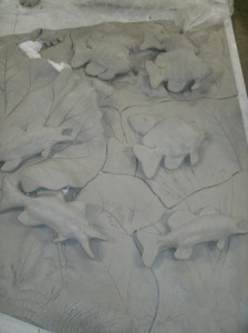 combining ceramic art fish into panel